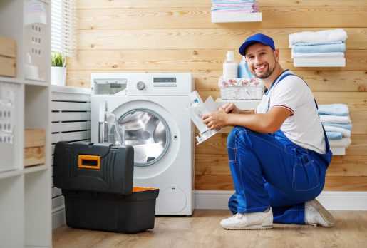 Engineer repairing a washing machine in Brighton